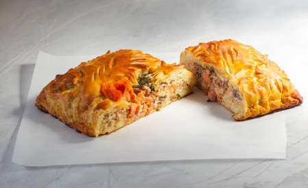 Tasty salmon pie, homemade. Yeast dough, fish stuffing, cut. Great for breakfast or fast snack.の写真素材