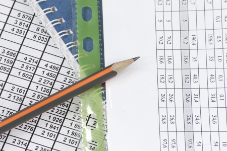 Business documents  report with different numbers and pencilの写真素材