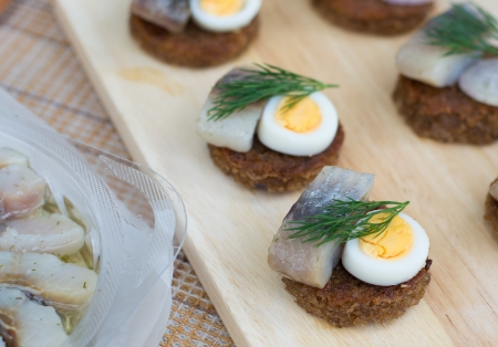 Small round canapes with herring, eggs and shallot の写真素材