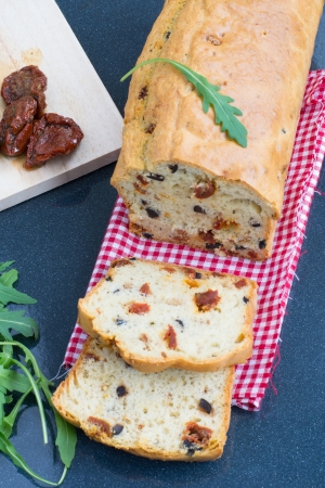 Snack cake with sun-dried tomatoes and black olives の写真素材