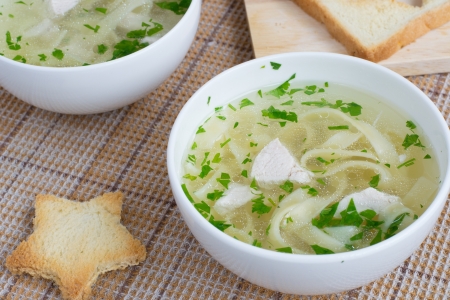 Chicken broth with pasta and parsleyの写真素材