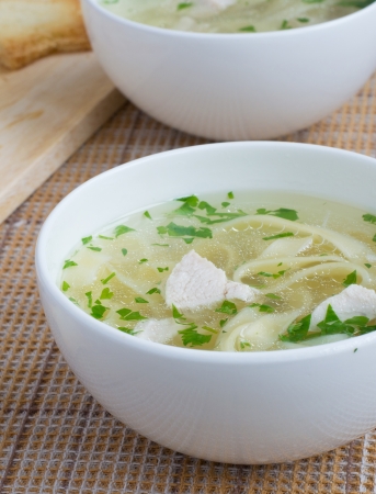 Chicken soup with noodles for dinnerの写真素材