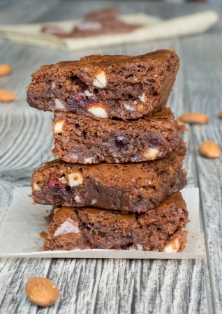 Tasty chocolate brownies with almonds and dry cranberries の写真素材