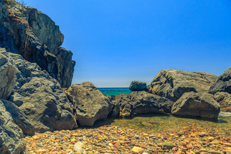 The rocky coast with pine tree overlooking the turquoise blue sea in warm summer day. Greece. Halkidikiの写真素材