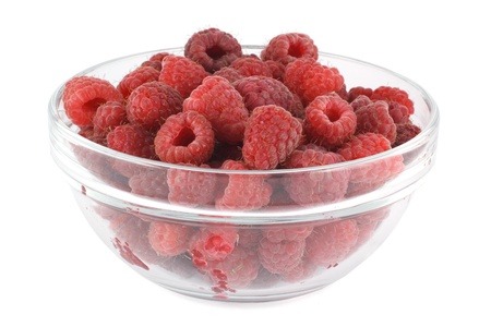Raspberries in a glass bowl isolated on whiteの写真素材