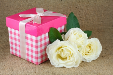 bouquet of roses and gift box on a linen canvasの写真素材