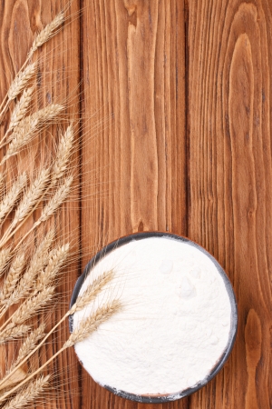 spikelets of wheat and flour a wooden board  top viewの写真素材
