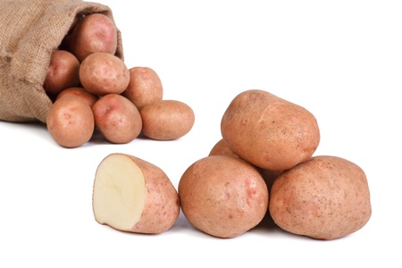 Raw potatoes cut and bag isolated on white backgroundの写真素材