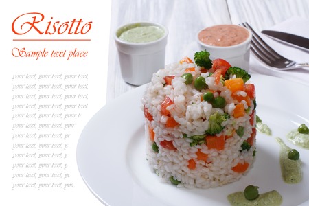 Vegetable risotto with two sauces isolated on a wooden tableの写真素材