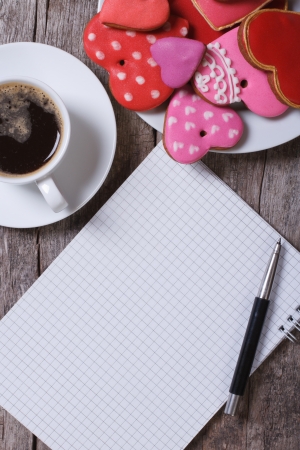 Black coffee, colorful heart cookies and a note  top viewの写真素材