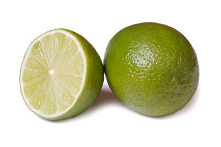 Whole and half fresh lime isolated on white background with soft shadow closeupの写真素材