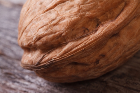 walnut in the shell close-up on an old wooden tableの写真素材