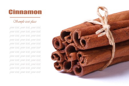 Bunch of cinnamon sticks closeup isolated on white background with text Macro の写真素材
