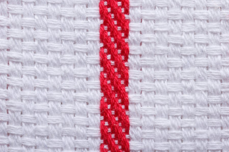 Texture of white cotton kitchen towel with a red stripe
