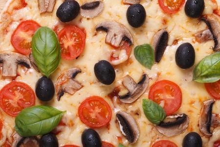 Texture pizza with mushrooms, olives, basil and cherry tomatoes. macroの写真素材