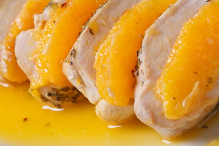Sliced chicken with orange slices in sauce closeup horizontal
の写真素材