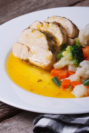 Sliced chicken with vegetables in orange sauce closeup. vertical 
の写真素材