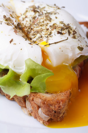 Eggs Benedict with bread on a plate