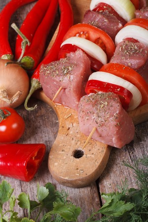 raw shashlik with vegetables on a chopping board. vertical. close up.
の写真素材