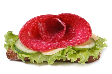 beautiful sandwich with salami, cheese and lettuce isolated on white background close-up. horizontal
の写真素材
