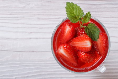 Delicious fresh strawberry drink with mint close up on the table top view 