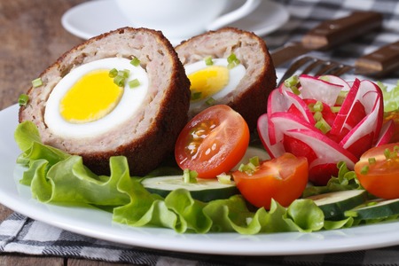 Meat stuffed with egg and vegetable salad on the plate closeup. horizontal
の写真素材