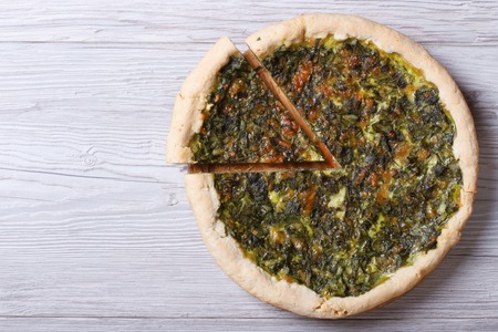 Open pies with herbs, cheese and spinach on a wooden table top view
の写真素材