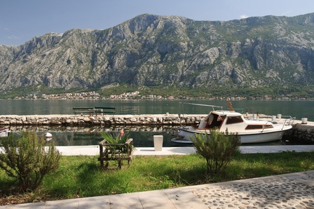 Embankment and a small dock in the Bay of Kotor in Montenegro.の写真素材