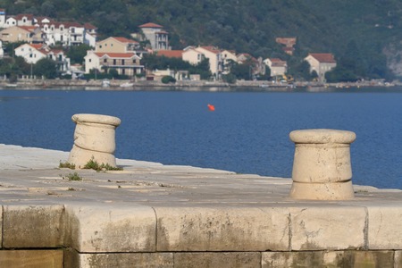 two stone bitt on a pier close up on a background of Kotor bay. Montenegroの写真素材