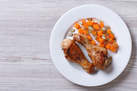 Fried chicken drumsticks with pumpkin closeup. view from above. horizontalの写真素材