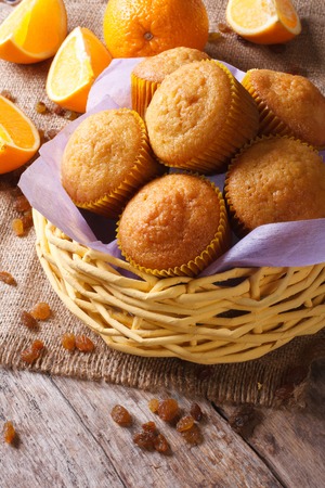 Delicious muffins with oranges and raisins on the table close-up. verticalの写真素材