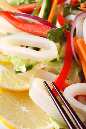 Japanese salad with vegetables and squid rings macro. verticalの写真素材