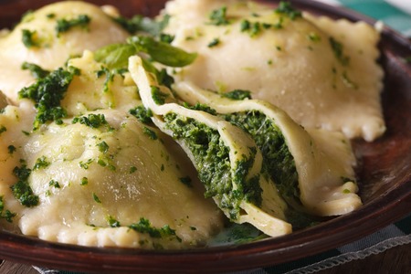 Italian ravioli stuffed with spinach and cheese macro on a brown plate. horizontal, rustic styleの写真素材