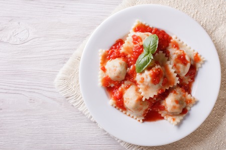 Ravioli with tomato sauce on a plate. horizontal view from aboveの写真素材