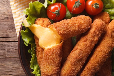 Hot fried cheese on a plate close-up, horizontal view from aboveの写真素材