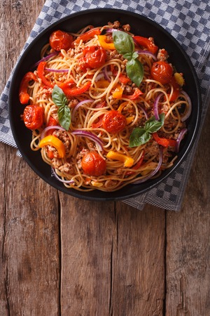 Spaghetti with minced meat and vegetables. vertical view above, rustic styleの写真素材