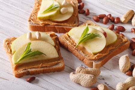 sweet toast with fresh apple and peanut butter on the table. Horizontalの写真素材
