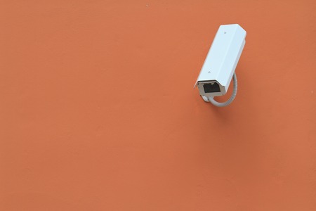 Surveillance camera on the wall close-up. horizontalの写真素材