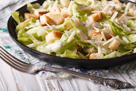 American Classic Caesar Salad close-up on a plate on the tableの写真素材