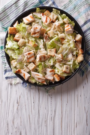 Caesar salad with chicken on the plate. vertical view from aboveの写真素材