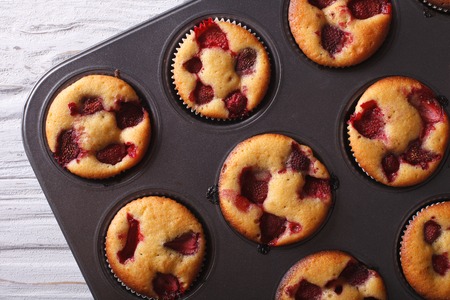 berry strawberry muffins close-up in baking dish. horizontal view from aboveの写真素材