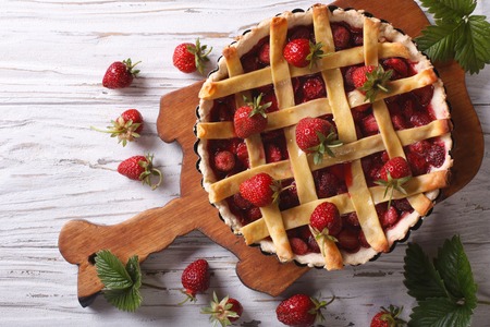 delicious strawberry pie in the baking dish on the table. vertical view above, rustic styleの写真素材