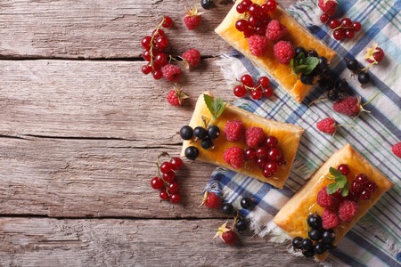 Delicious cookies with berries, honey and mint on a table. horizontal top viewの写真素材