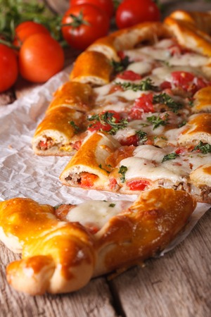Sliced pie Turkish pide close up on the table and ingredientsの写真素材