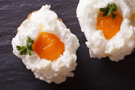 Eggs Orsini: baked whipped whites and yolks on a table close-up. horizontal view from aboveの写真素材
