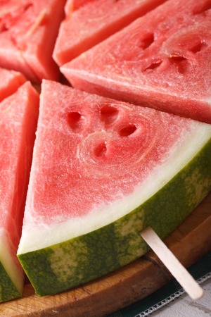 slices of fresh watermelon on a stick macro. verticalの写真素材