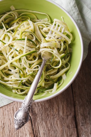Dietary zucchini pasta in a bowl closeup on the table. vertical view from aboveの写真素材