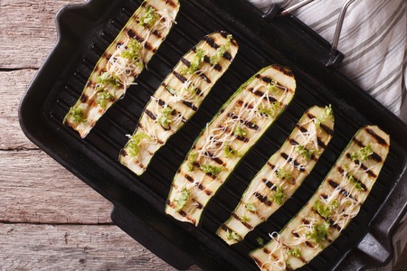 Low calorie grilled zucchini with cheese on a grill pan close-up. horizontal view from aboveの写真素材