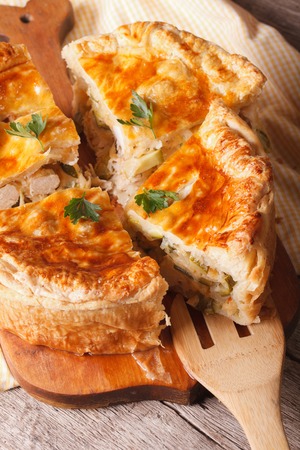 Homemade chicken pie sliced close-up on the table. vertical, rusticの写真素材