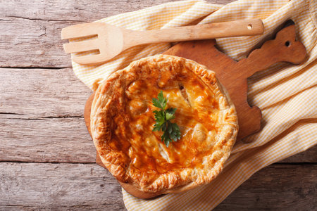 Homemade chicken pie close-up on the table. horizontal view from above